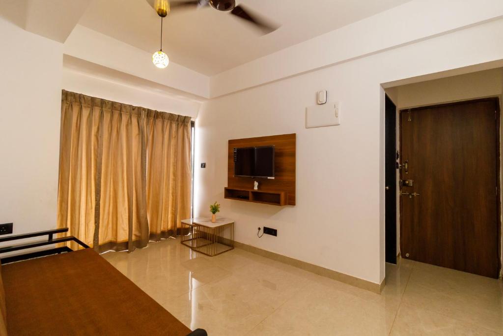 a living room with a flat screen tv on the wall at Casa Quina Heritage#5 in Taleigao