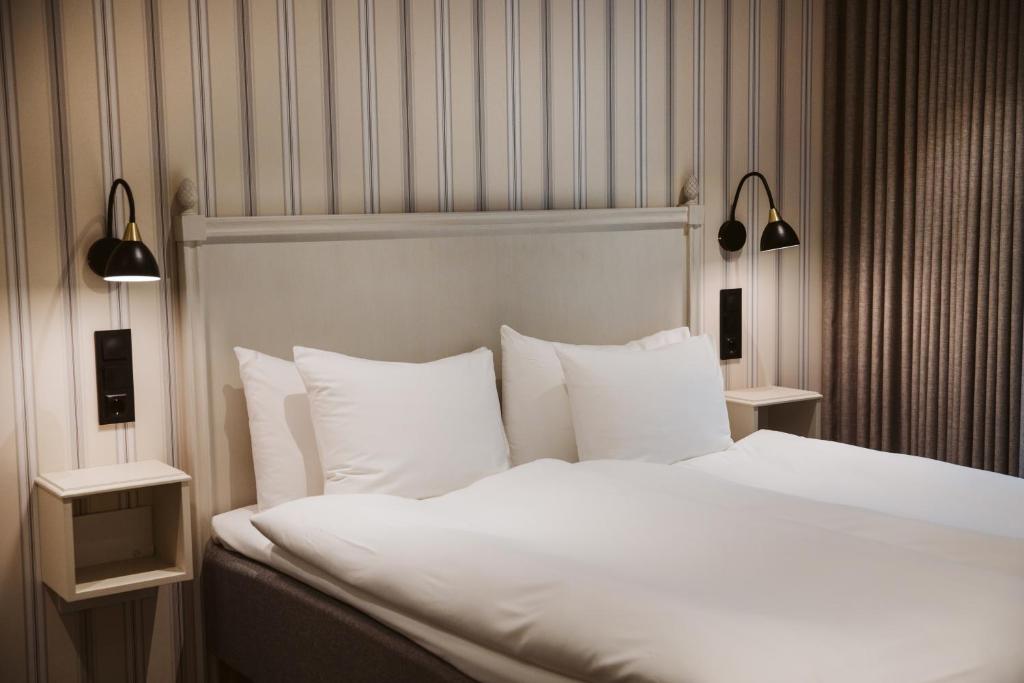 Postel nebo postele na pokoji v ubytování Hotel Rusthållargården