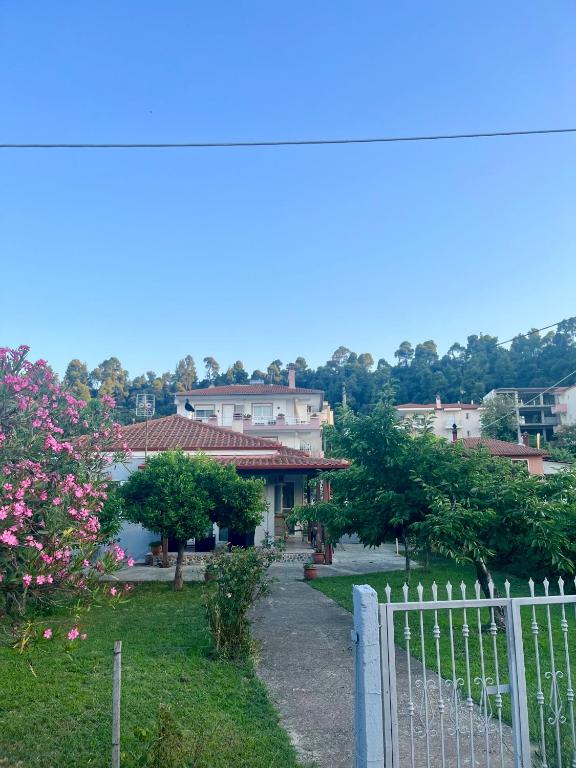 a white fence in front of a house at Beverly house in Kriopigi