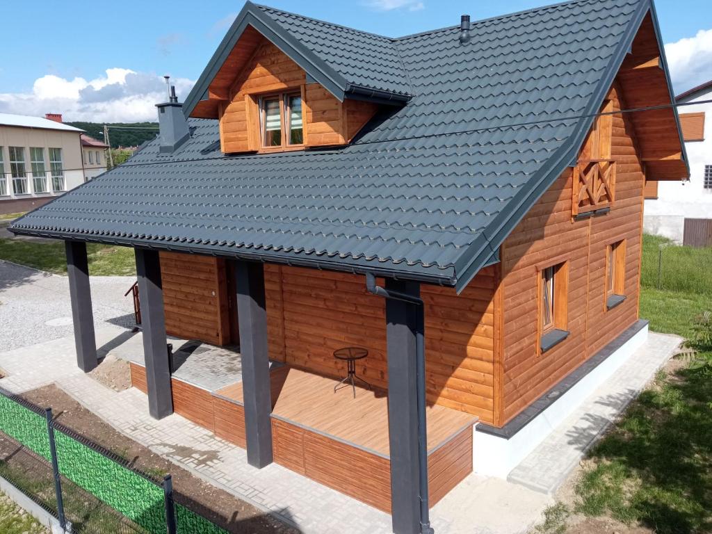 a house with a roof on top of it at Domek pod Lipą in Nienaszów