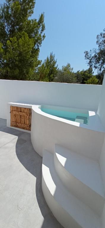 a white toilet sitting on top of a patio at Kyklades Sensation Private Plunge Pool Romantic Suite in Artemida