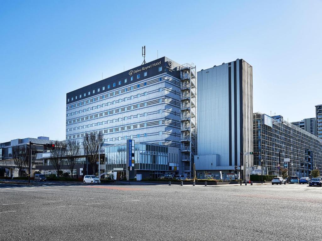 a large glass building in the middle of a city at Daiwa Roynet Hotel Tsukuba in Tsukuba