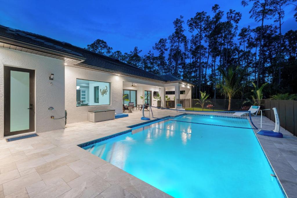 a swimming pool in the backyard of a house at Quiet 5-br House Heated Pool And Outdoor Kitchen in Naples