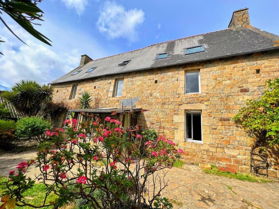 a brick house with flowers in front of it at Grande maison de famille - Le Petit Pontébart in Paimpol