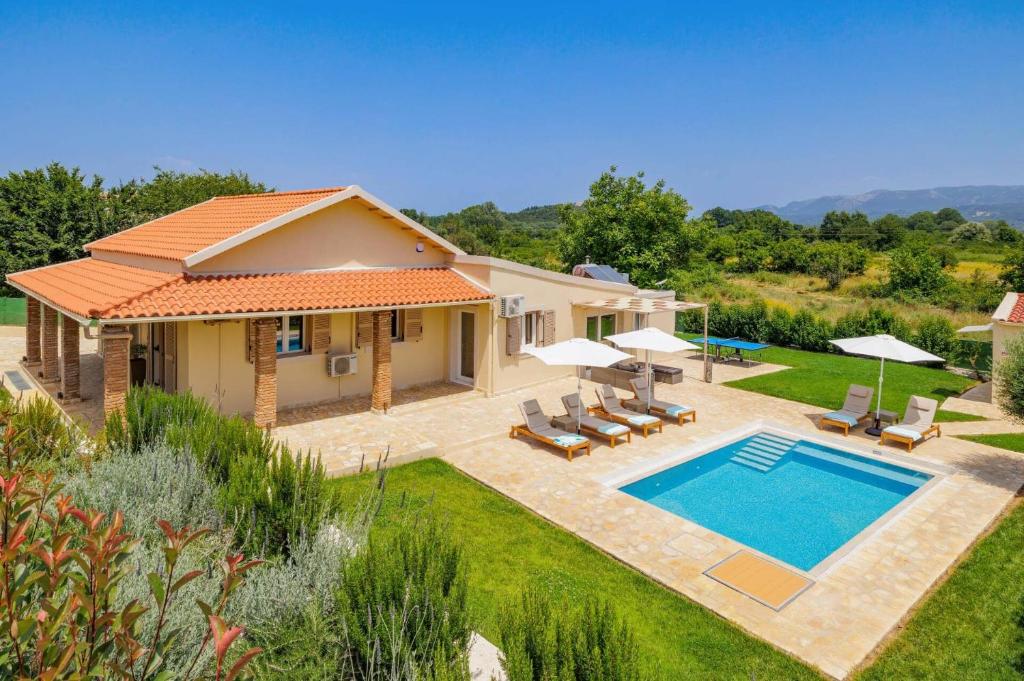 a house with a swimming pool in a yard at Villa Stamatella by Villa Plus in Velonádes