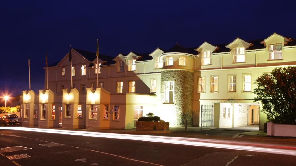 a large building on a city street at night at Ballyliffin Hotel in Ballyliffin