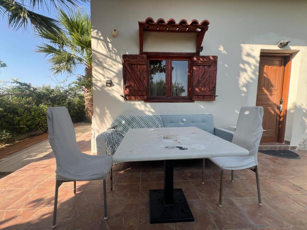 a white table and chairs on a patio at Country house in nature in Heraklion