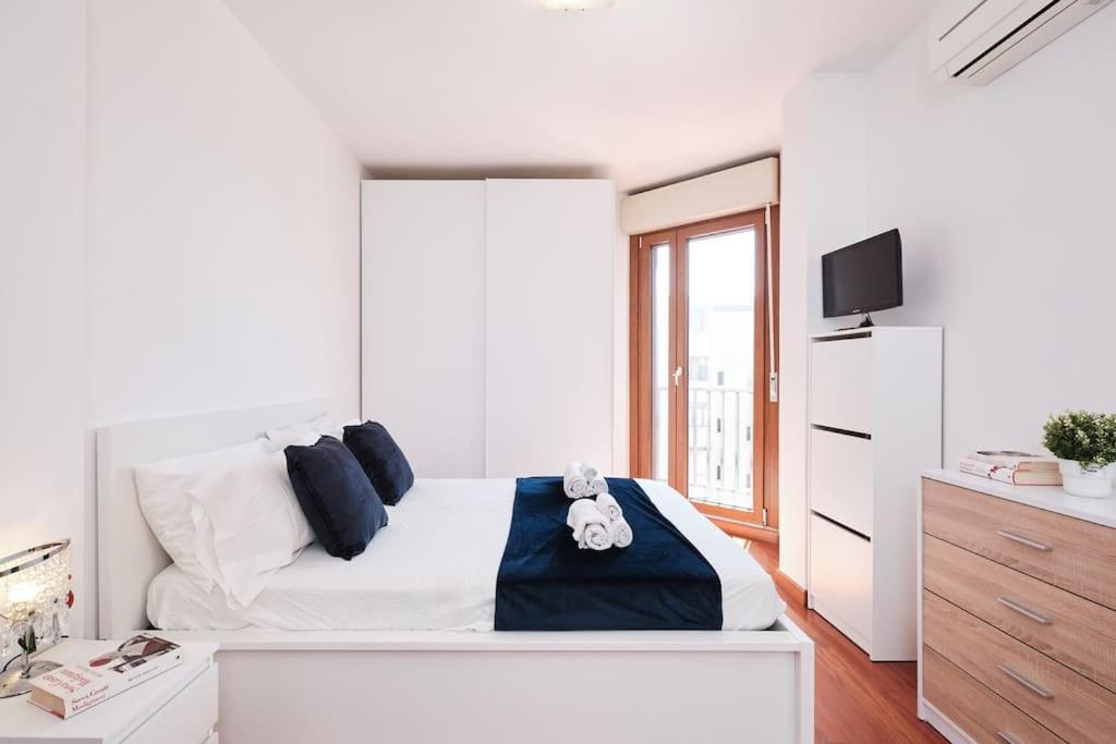 Postel nebo postele na pokoji v ubytování Porta di Roma, Moderno Luminoso con Wi-Fi e AC