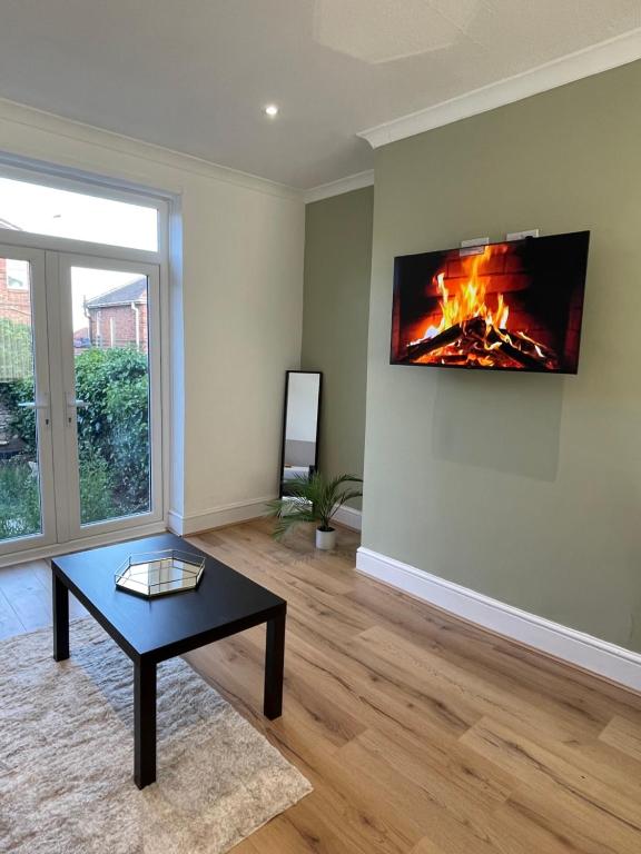 un salon avec une cheminée au mur dans l'établissement Whole House Modern Two Bedroom in Newcastle - Free Parking, à Newcastle upon Tyne