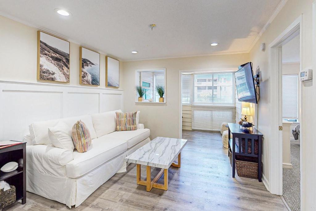 a living room with a white couch and a table at Spa on Port Royal Sound 3121 in Hilton Head Island