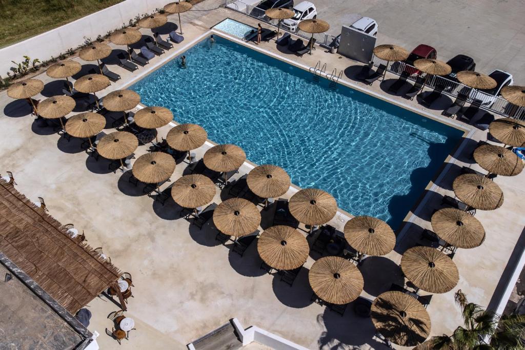 an overhead view of a swimming pool with umbrellas at Elion Seaside Resort in Eretria