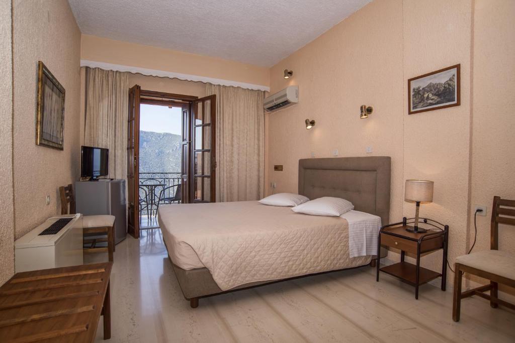 Postel nebo postele na pokoji v ubytování Olympic Hotel