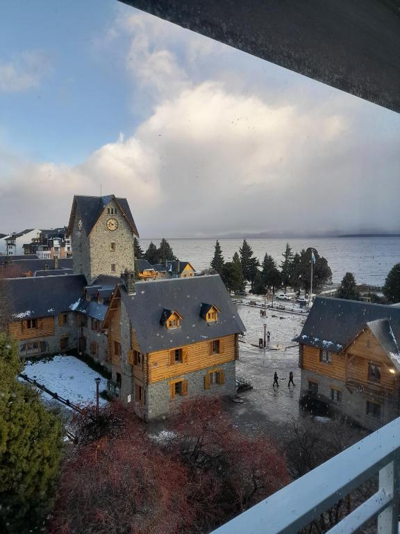 a group of buildings with snow on the roofs at Viena I by Tirol in San Carlos de Bariloche