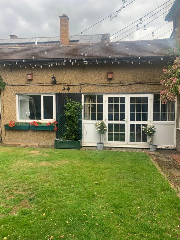 a house with a lawn in front of it at 1 mile from Harry Potter Tour Self Contained Flat One bedroom plus new sofa bed in lounge in Abbots Langley