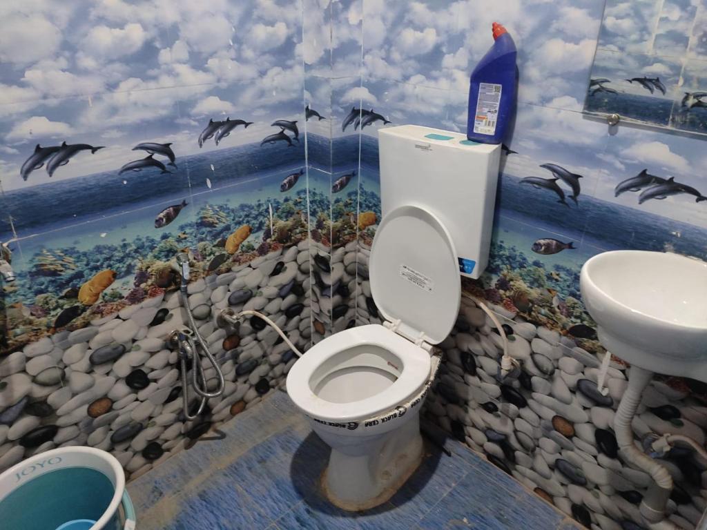 a bathroom with a toilet and a sink at Awadh Royals Homestay Ayodhya in Ayodhya