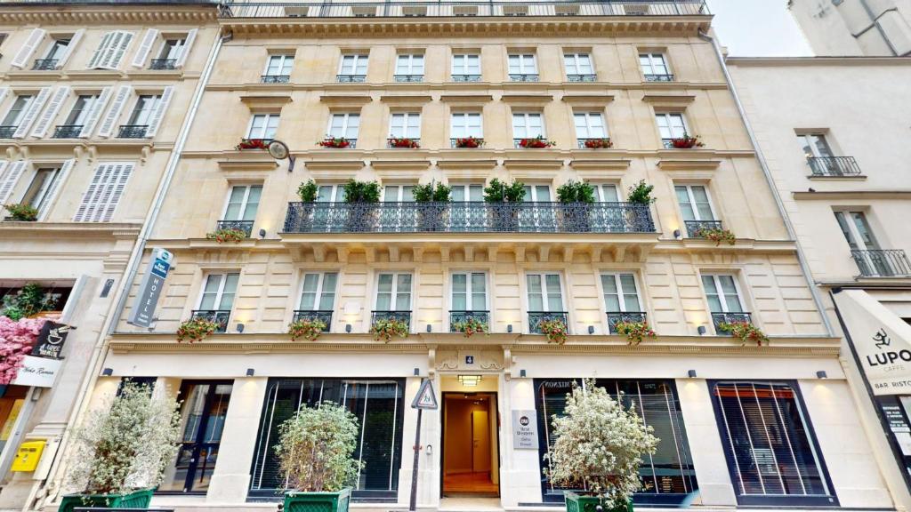 a building in paris with potted plants on it at Best Western Hotel Opéra Drouot in Paris