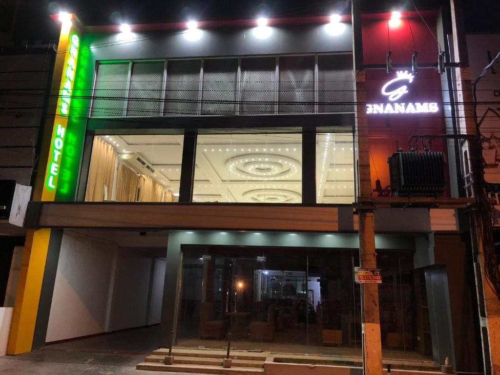 a building with a sign on the side of it at Gnaanams Hotel and Restaurant in Jaffna