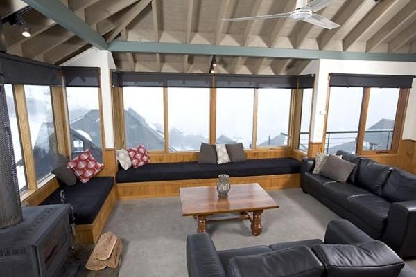 a living room with couches and a coffee table at Eagles Nest in Mount Hotham