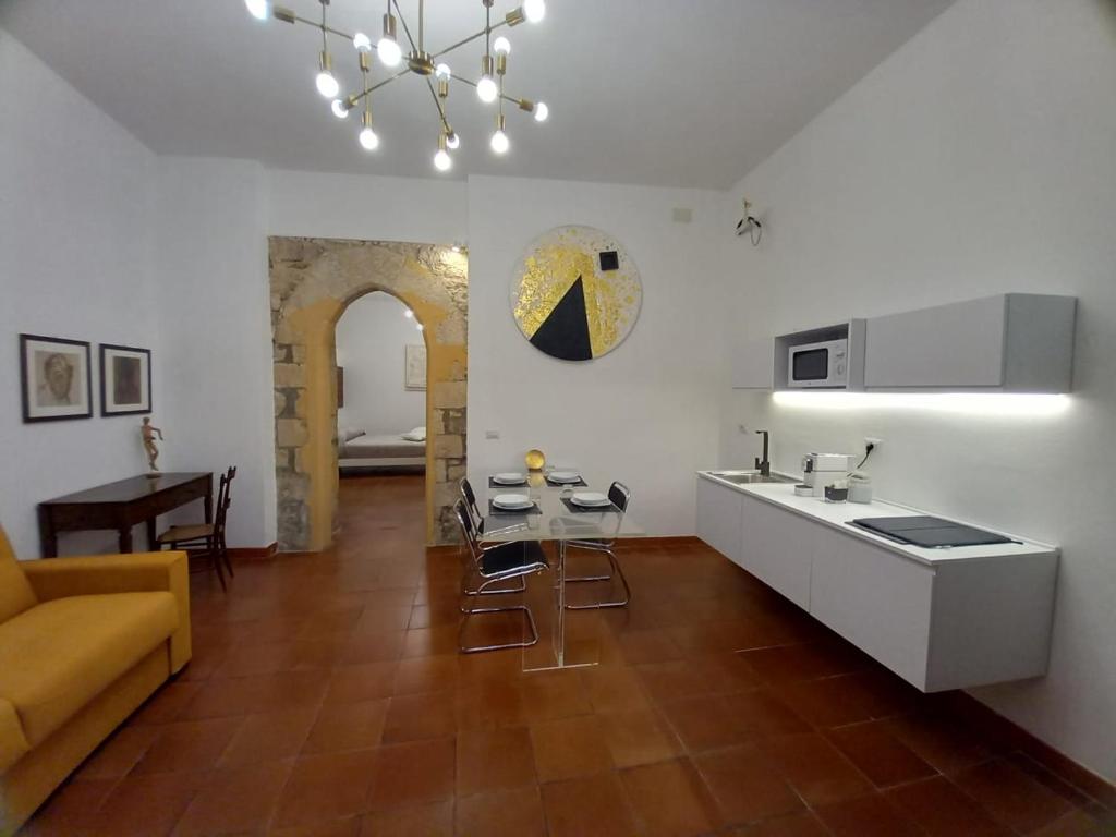 a kitchen and living room with a couch and a table at New Design Ortigia in Siracusa