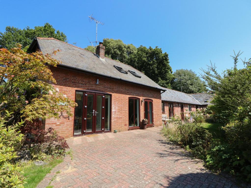 a brick building with a driveway in front of it at Northern Byre in Christchurch