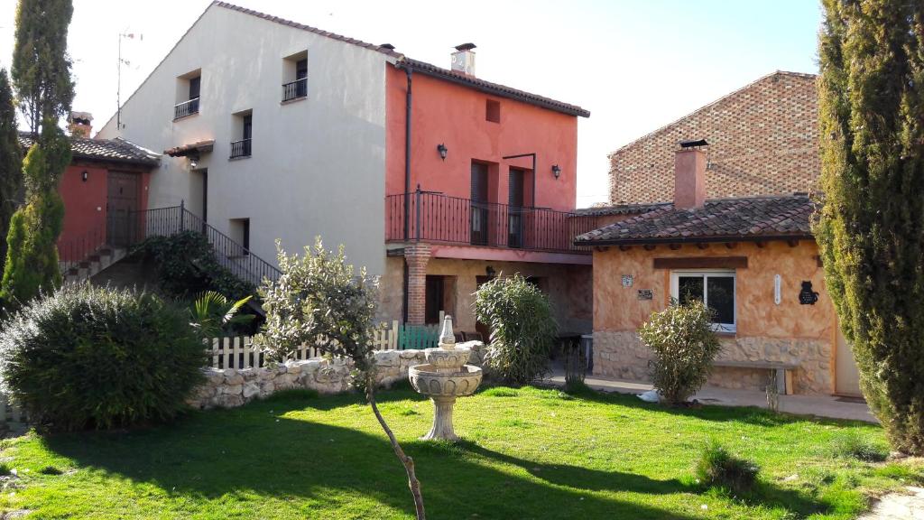 a group of buildings in a yard with trees at Casa Rural Valle del Duero in Langa de Duero