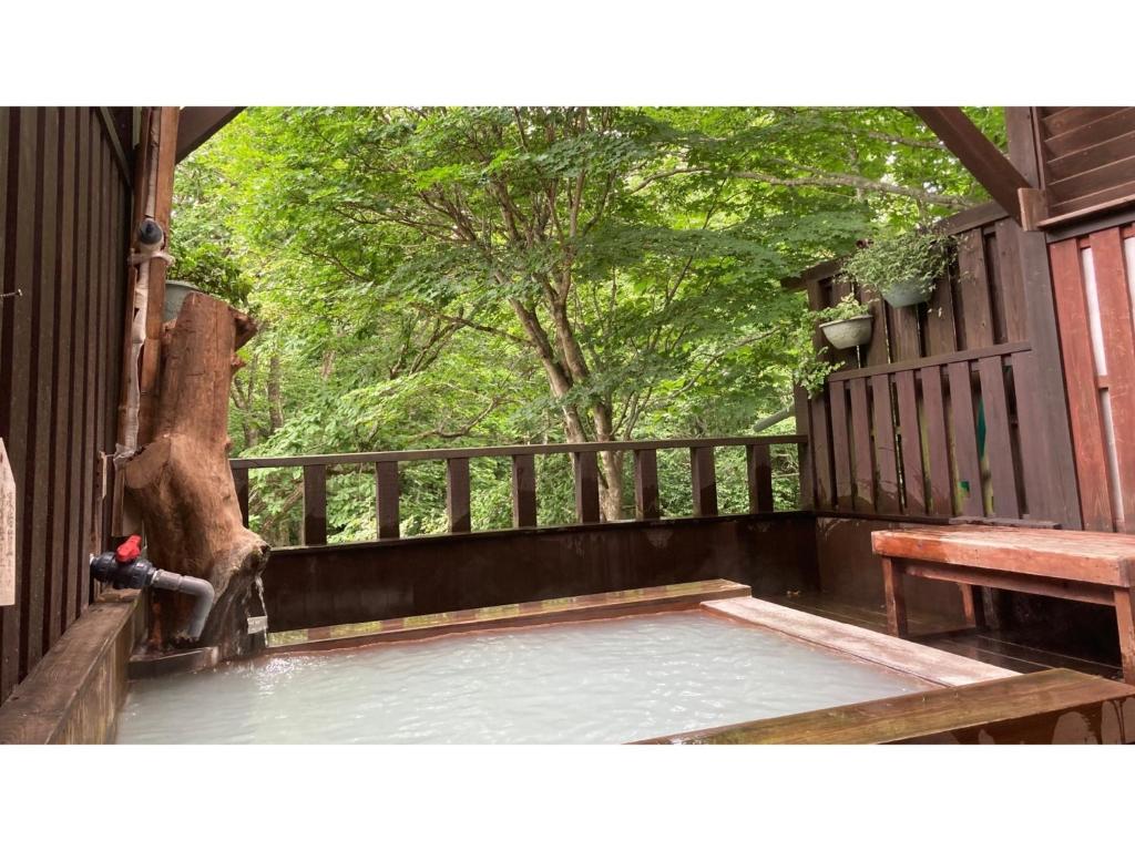 a porch with a wooden fence and a bench at Shinyu Onsen Kurikomaso - Vacation STAY 45507v in Kurihara