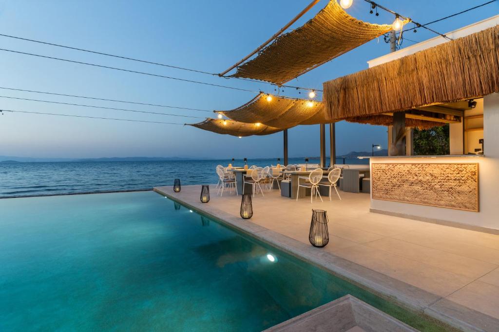 a villa with a swimming pool and a restaurant at NOIMA Casa Unico in Megalochori