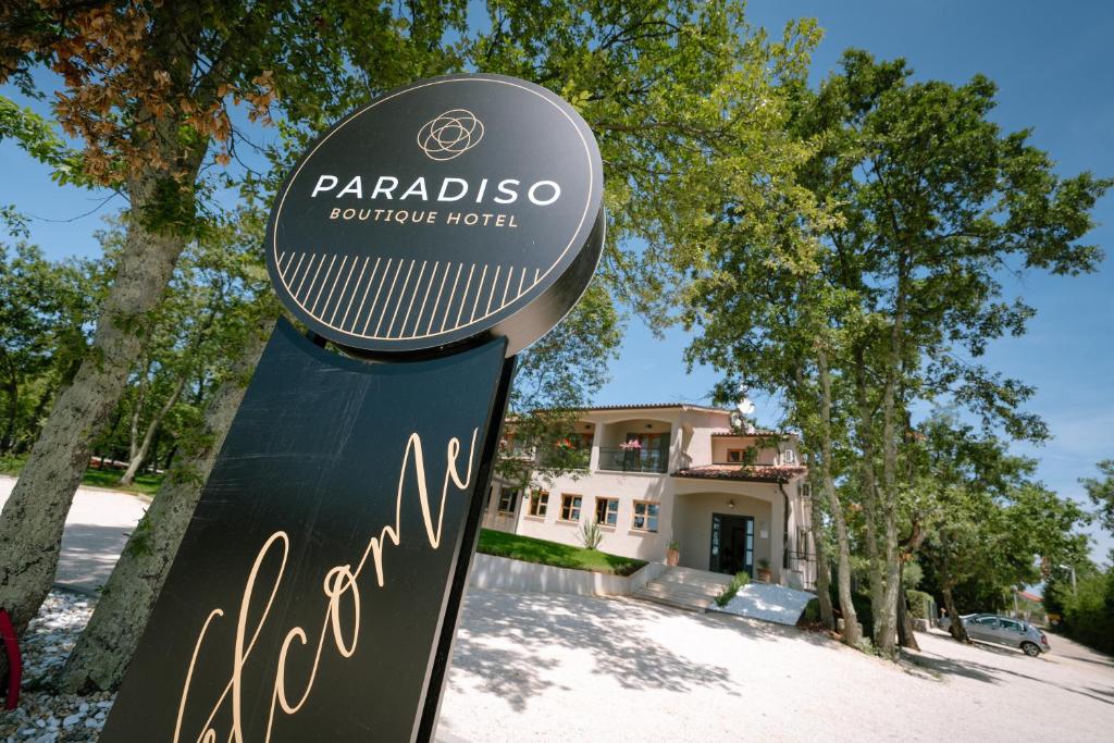 un cartel para un hotel boutique parabiso frente a una casa en Boutique Hotel Paradiso, en Poreč