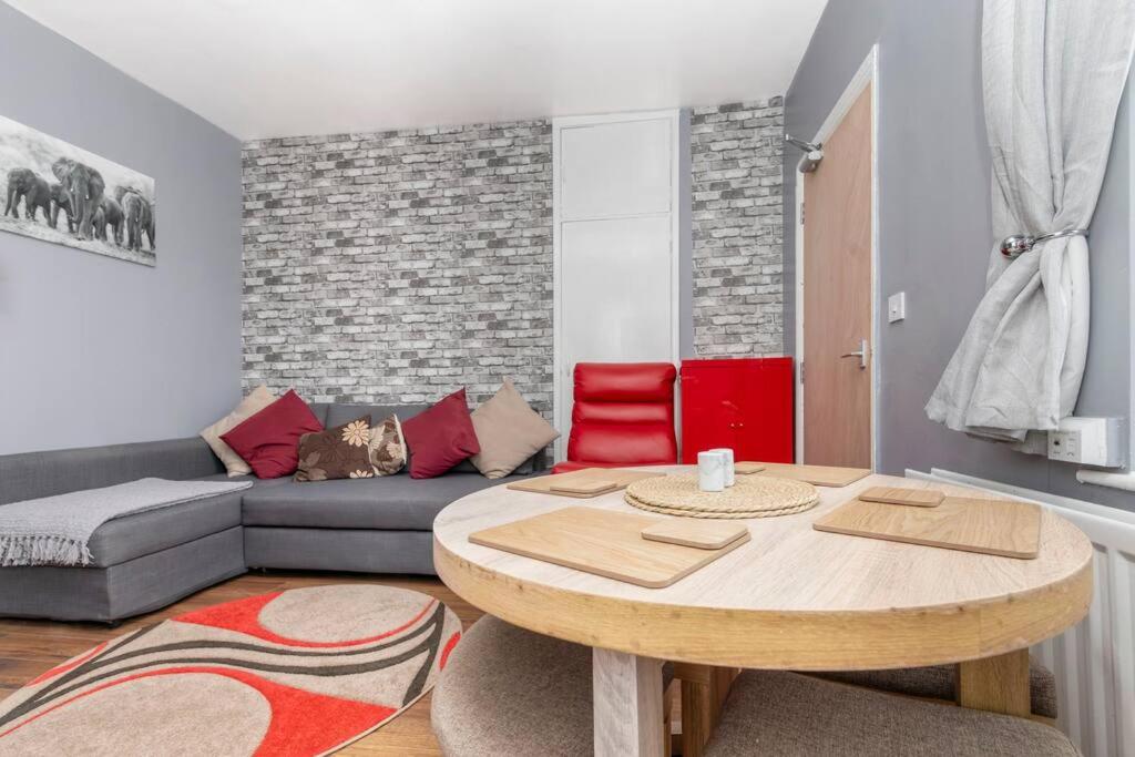 a living room with a table and a couch at Saltwell Place Gateshead in Gateshead