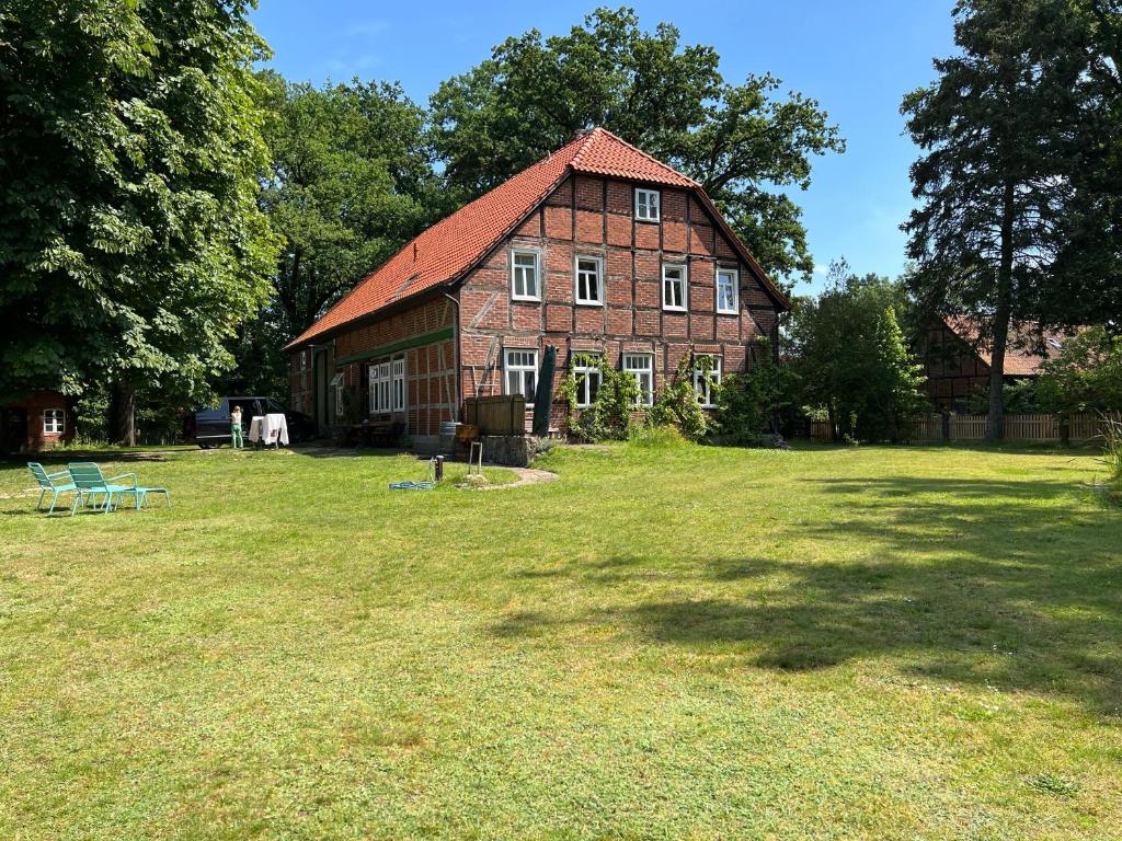 a large red brick barn with a large yard at Wendlandhof Lüggau in Dannenberg
