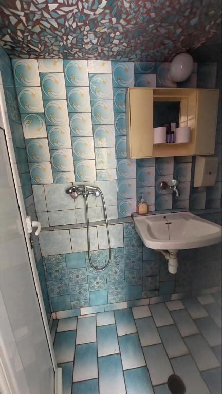 a bathroom with a sink and a shower in it at Old town Room With Window in Rethymno