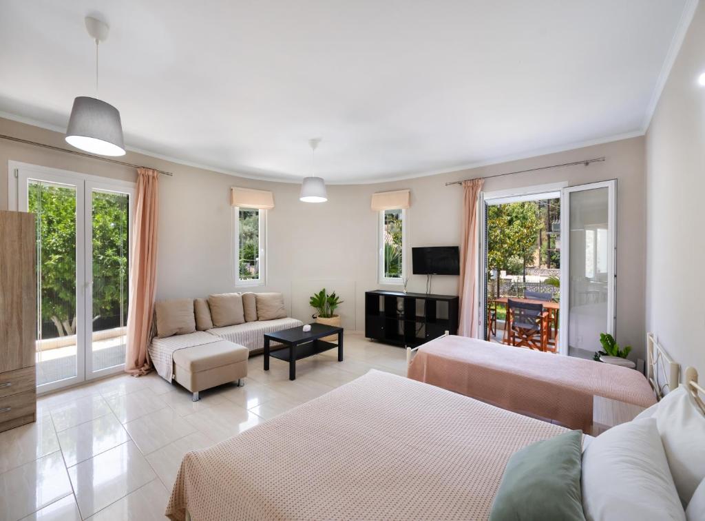 a large living room with two beds and a couch at Apricus1 in Apolpaina