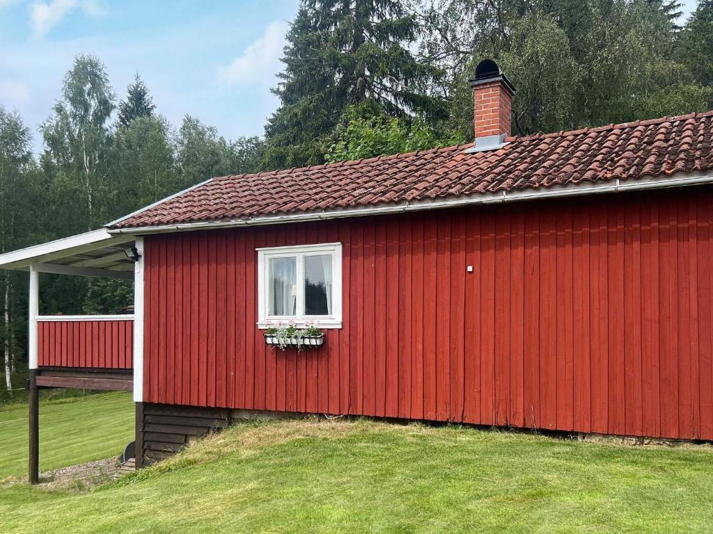 a red building with a window and a flower box at 4 person holiday home in MOLKOM-By Traum in Molkom