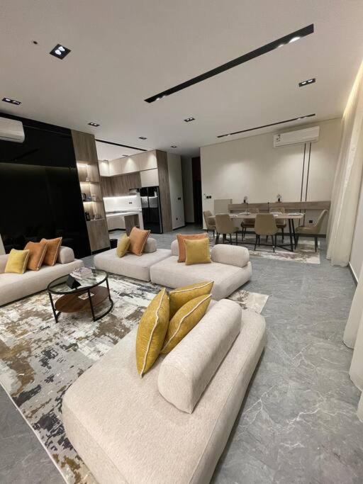 a living room with couches and a dining room at The N&N Appt in Medina