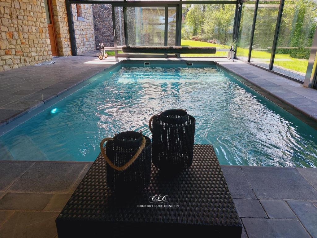 a swimming pool with a bench in the water at Villa VIP in Welkenraedt