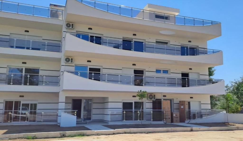 an apartment building with balconies on the side at Alexandra Comfort Apartments in Keramotí