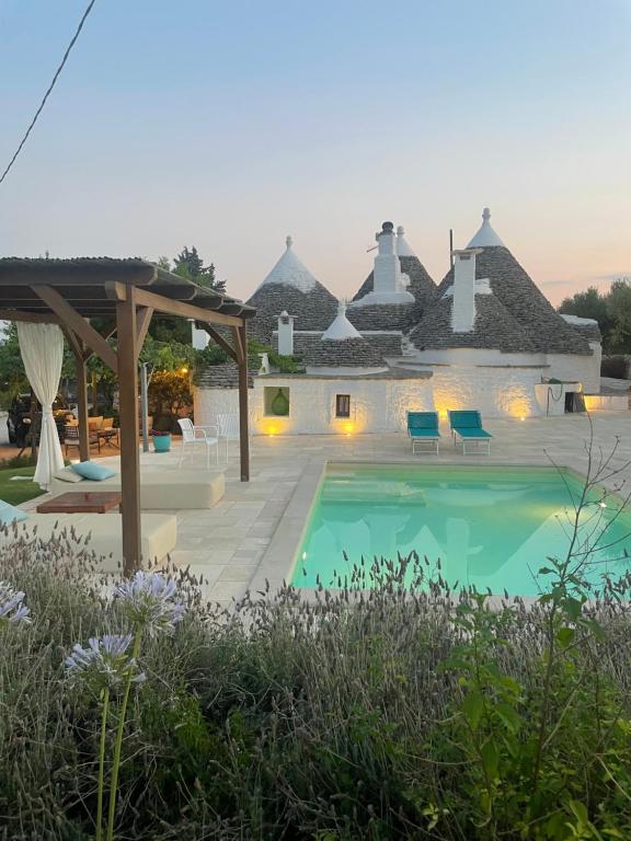 a villa with a swimming pool and a resort at Trullo Matilde in Martina Franca