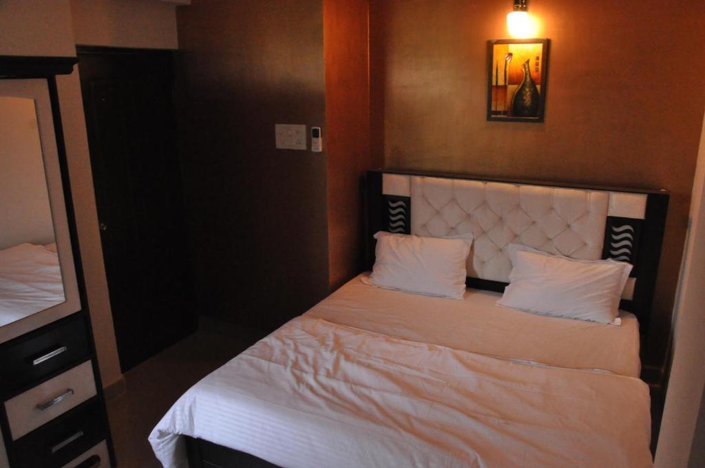 Postel nebo postele na pokoji v ubytování Hotel Dewa Goa