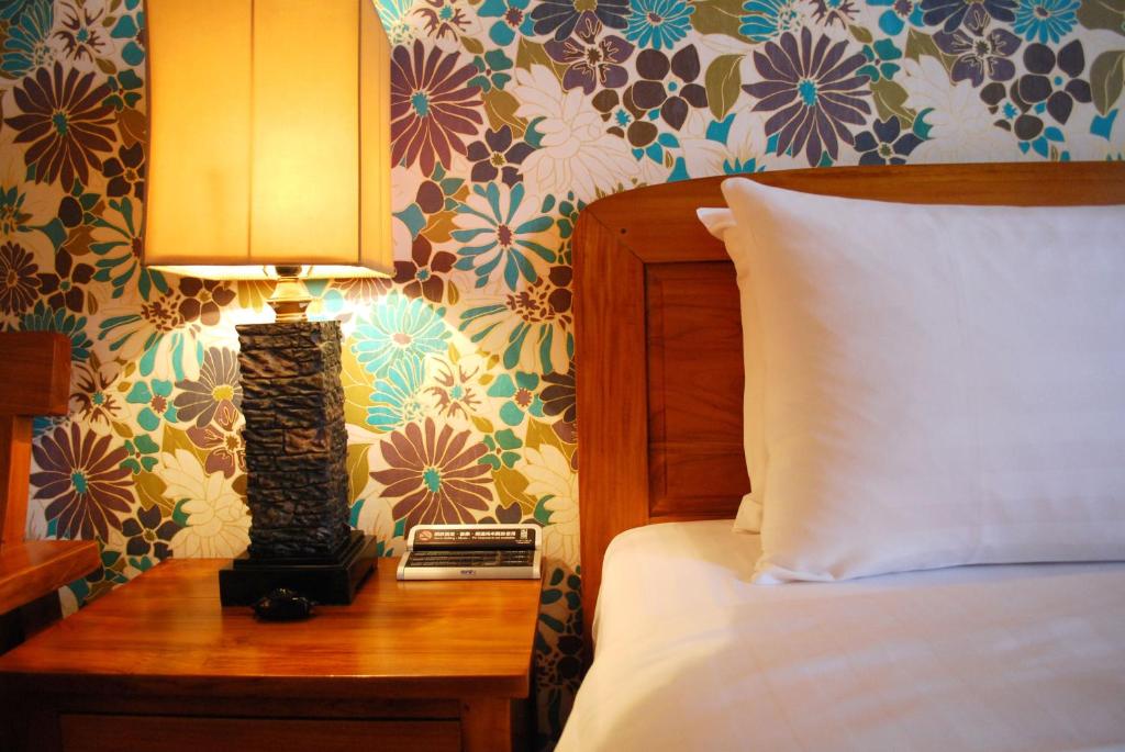 Postel nebo postele na pokoji v ubytování Yentai Hotel
