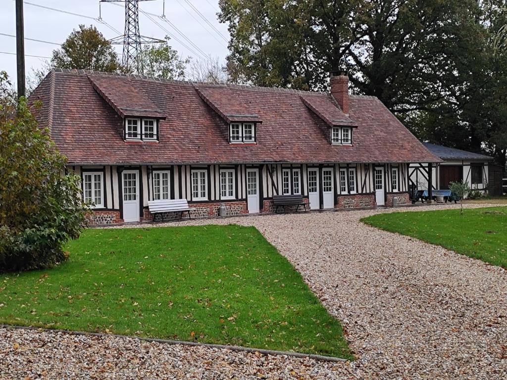 an old house with a large yard in front of it at Gîte Le Clos Maridor - Grande Longère Normande -15 personnes in Saint-Martin-Saint-Firmin