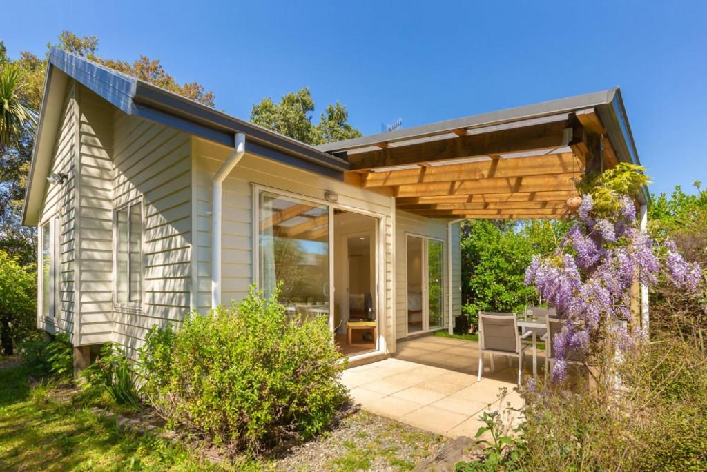 a home with a patio with a pergola at Estuary Escape Mapua in Mapua