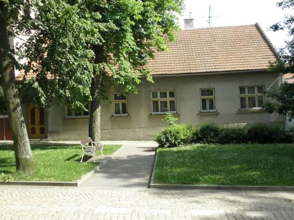 una silla frente a una casa con patio en Penzion Mika en Jindrichuv Hradec