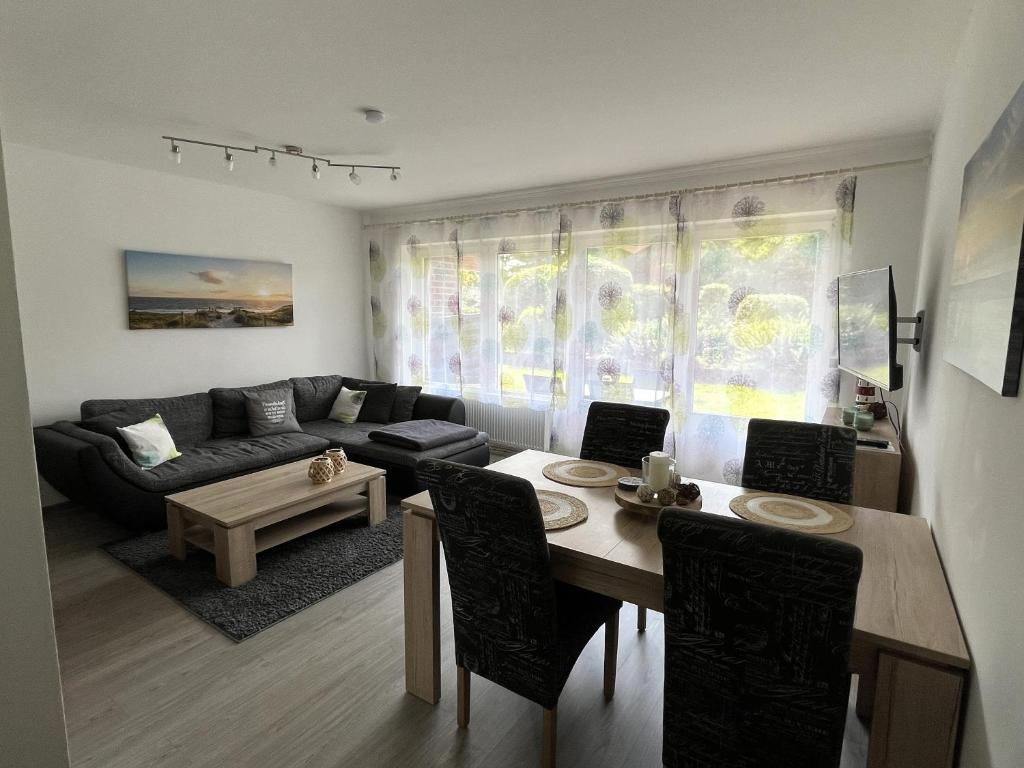 a living room with a couch and a table at Apartment Jadewind, Humenser 8a in Dangast