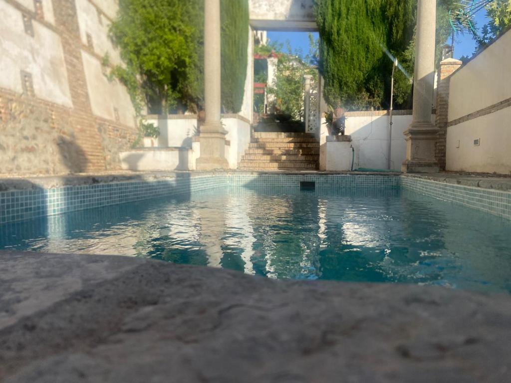 a pool of water in front of a building at Carmen de Belen in Granada