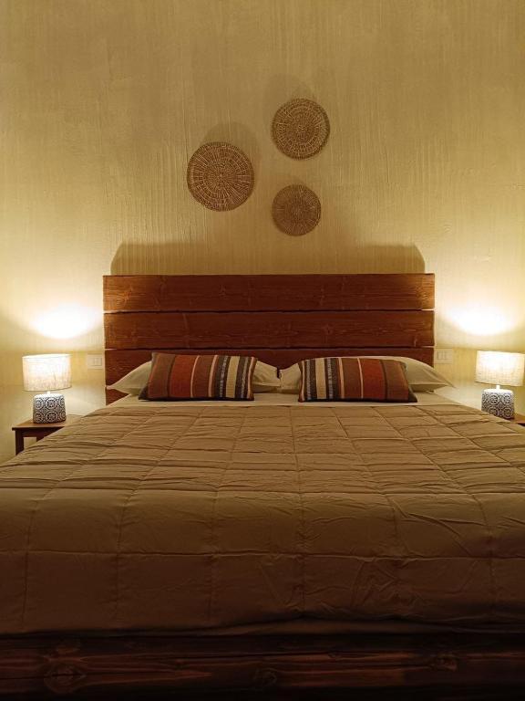 a bedroom with a large bed with two lamps at Pangea - Africa in Trani