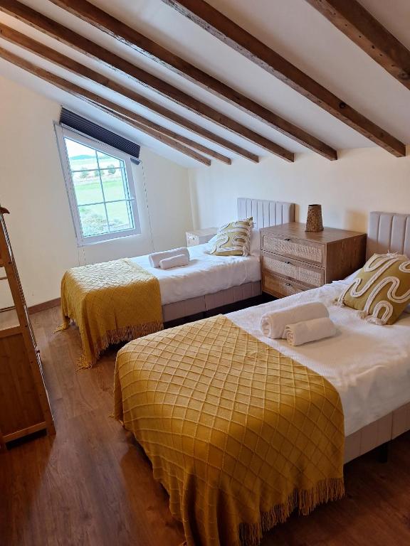 a bedroom with two beds and a window at Parque Remonta in Santander