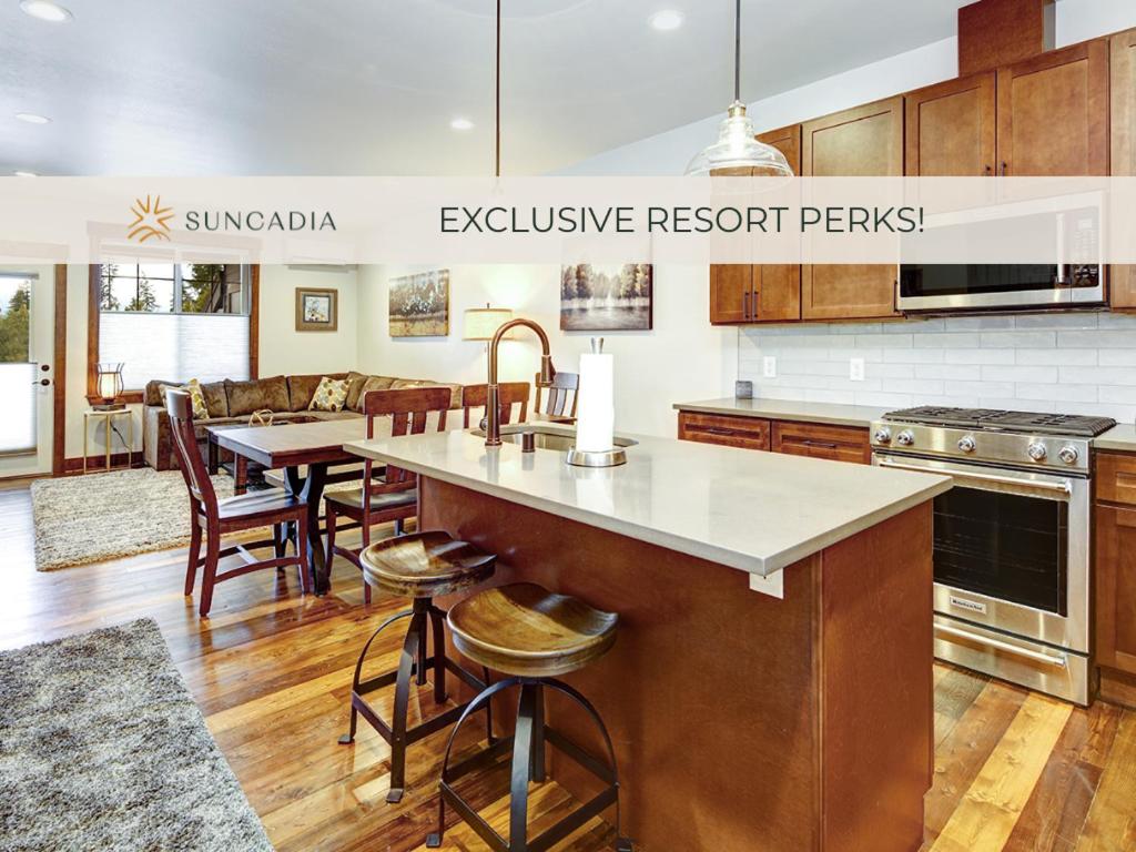 a kitchen with a large island with a table and chairs at Great Location Near Pool with Suncadia Pool Access in Cle Elum