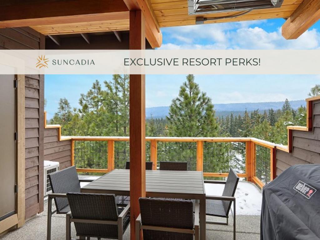 a patio with a table and chairs on a deck at Great Location Near Pool with Suncadia Pool Access in Cle Elum