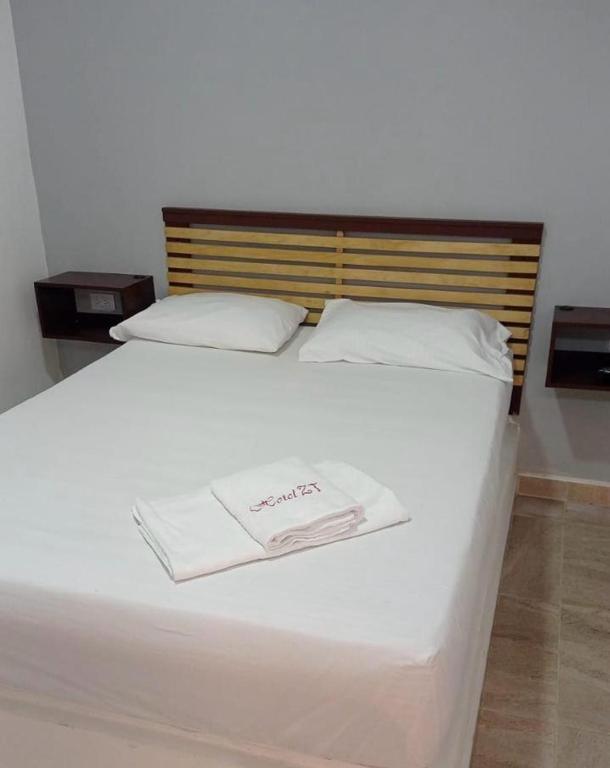 Postel nebo postele na pokoji v ubytování Hotel ZT