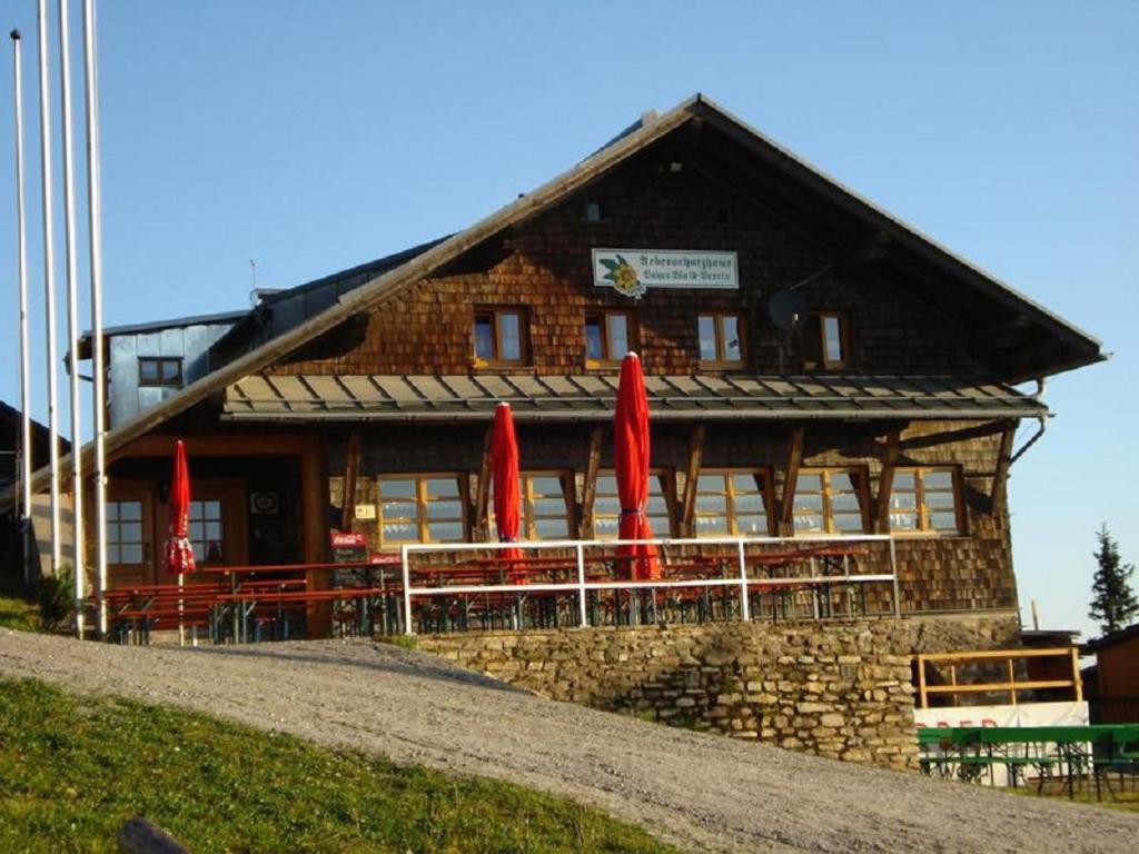 um edifício com guarda-chuvas vermelhos em frente em Arberschutzhaus em Bayerisch Eisenstein